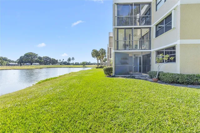 a view of a house with a garden and a lake view