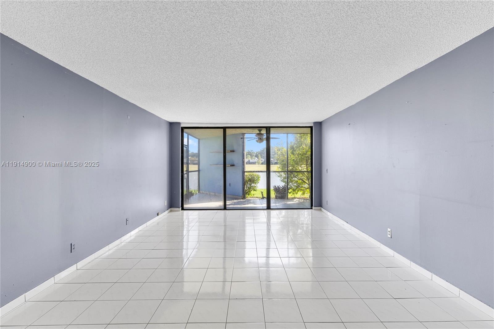 16100 Golf Club Road, Unit 101 Weston, FL 33326 - Photo 4 of 35 a view of an empty room with a window