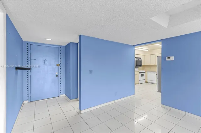 a view of an empty room and a bathroom