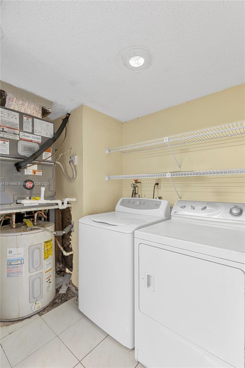 16100 Golf Club Road, Unit 101 Weston, FL 33326 - Photo 10 of 35 a utility room with dryer and washer