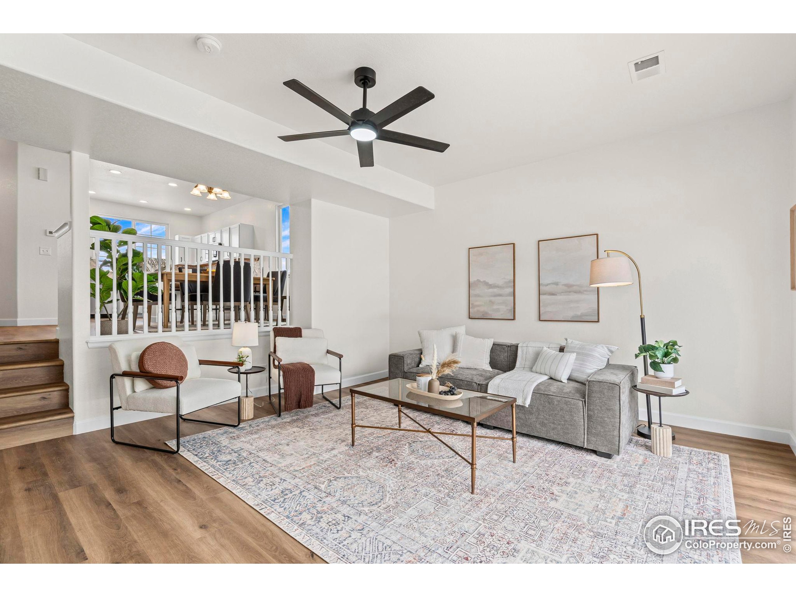 7324 Atlantis Street Wellington, CO 80549 - Photo 12 of 31 a living room with furniture and a wooden floor
