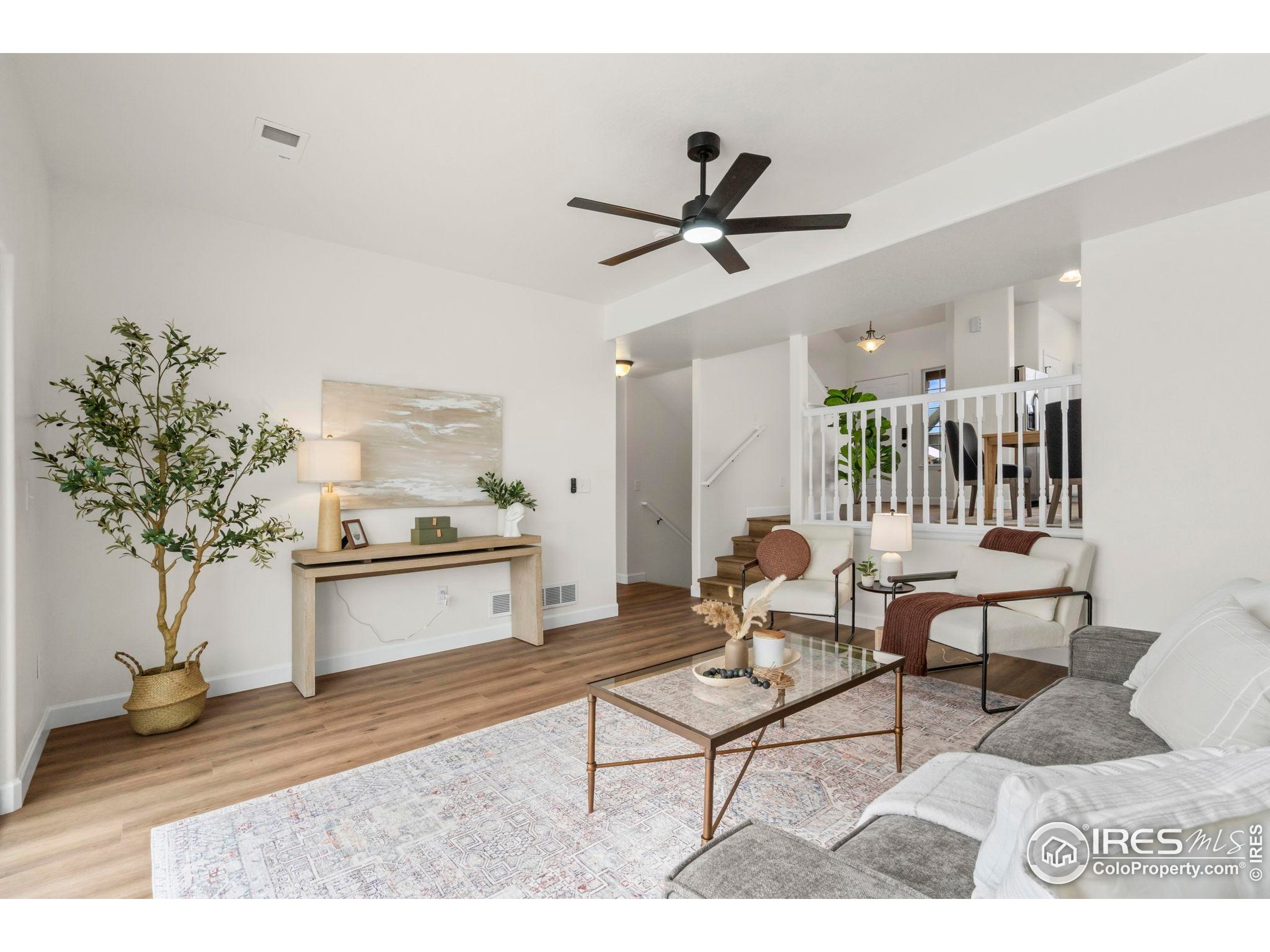 7324 Atlantis Street Wellington, CO 80549 - Photo 14 of 31 a living room with furniture and a potted plant