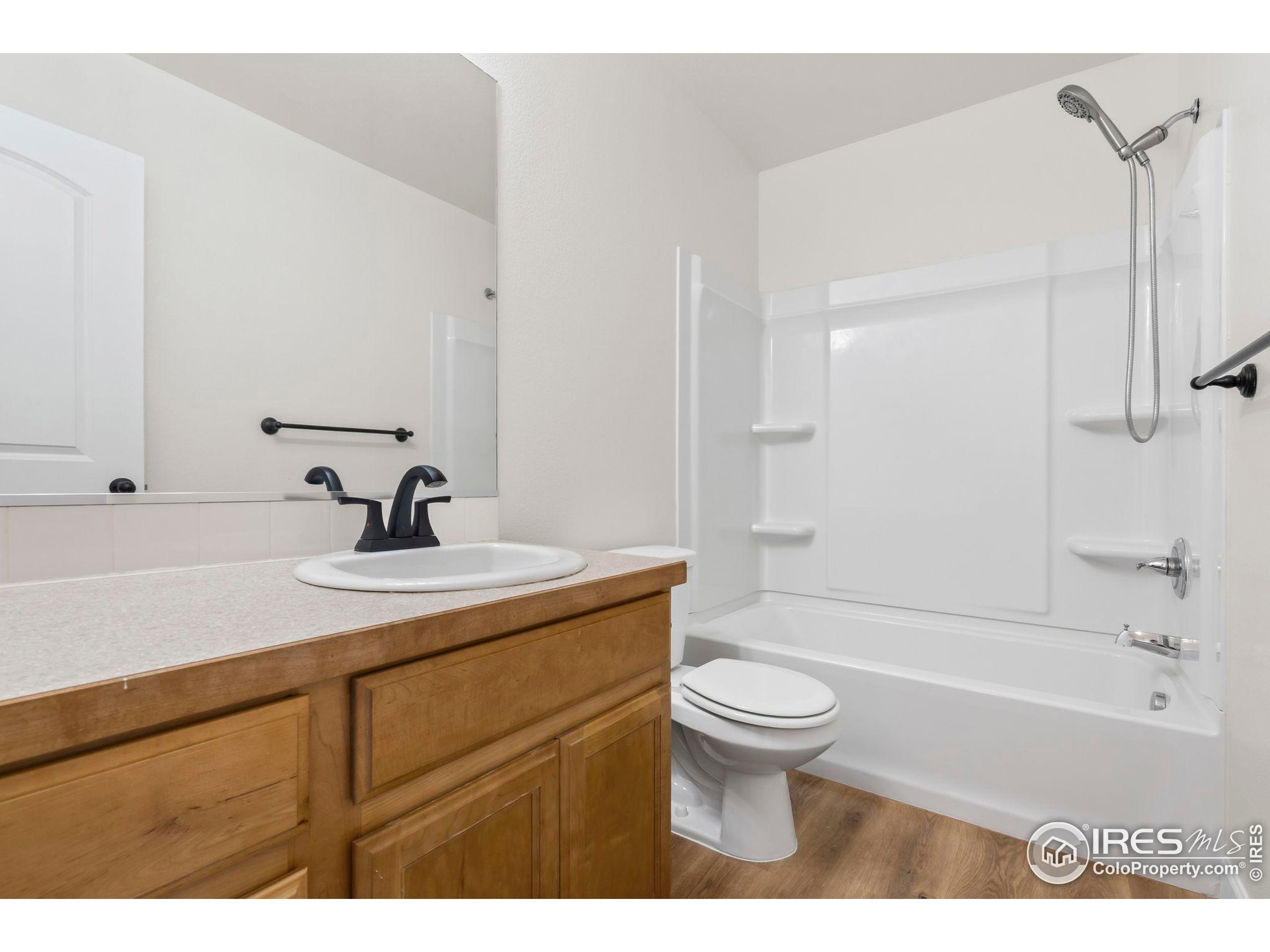 7324 Atlantis Street Wellington, CO 80549 - Photo 18 of 31 a bathroom with a sink a toilet and shower