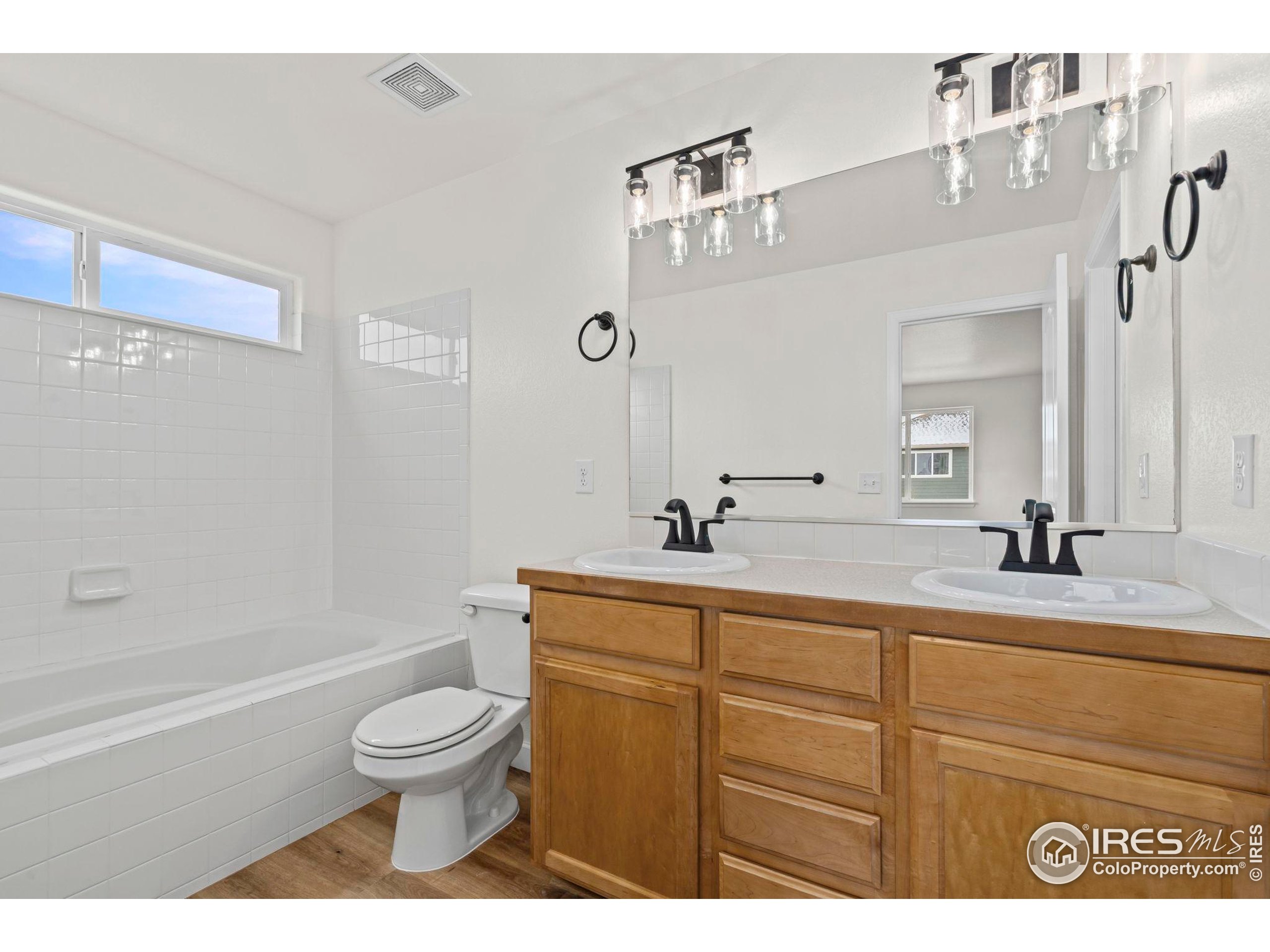 7324 Atlantis Street Wellington, CO 80549 - Photo 24 of 31 a bathroom with a sink a toilet and a bathtub