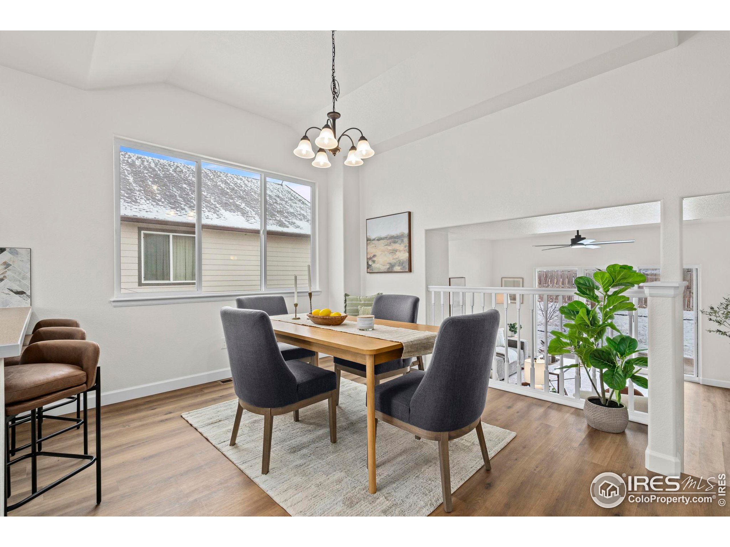 7324 Atlantis Street Wellington, CO 80549 - Photo 3 of 31 a view of a dining room with furniture and a chandelier