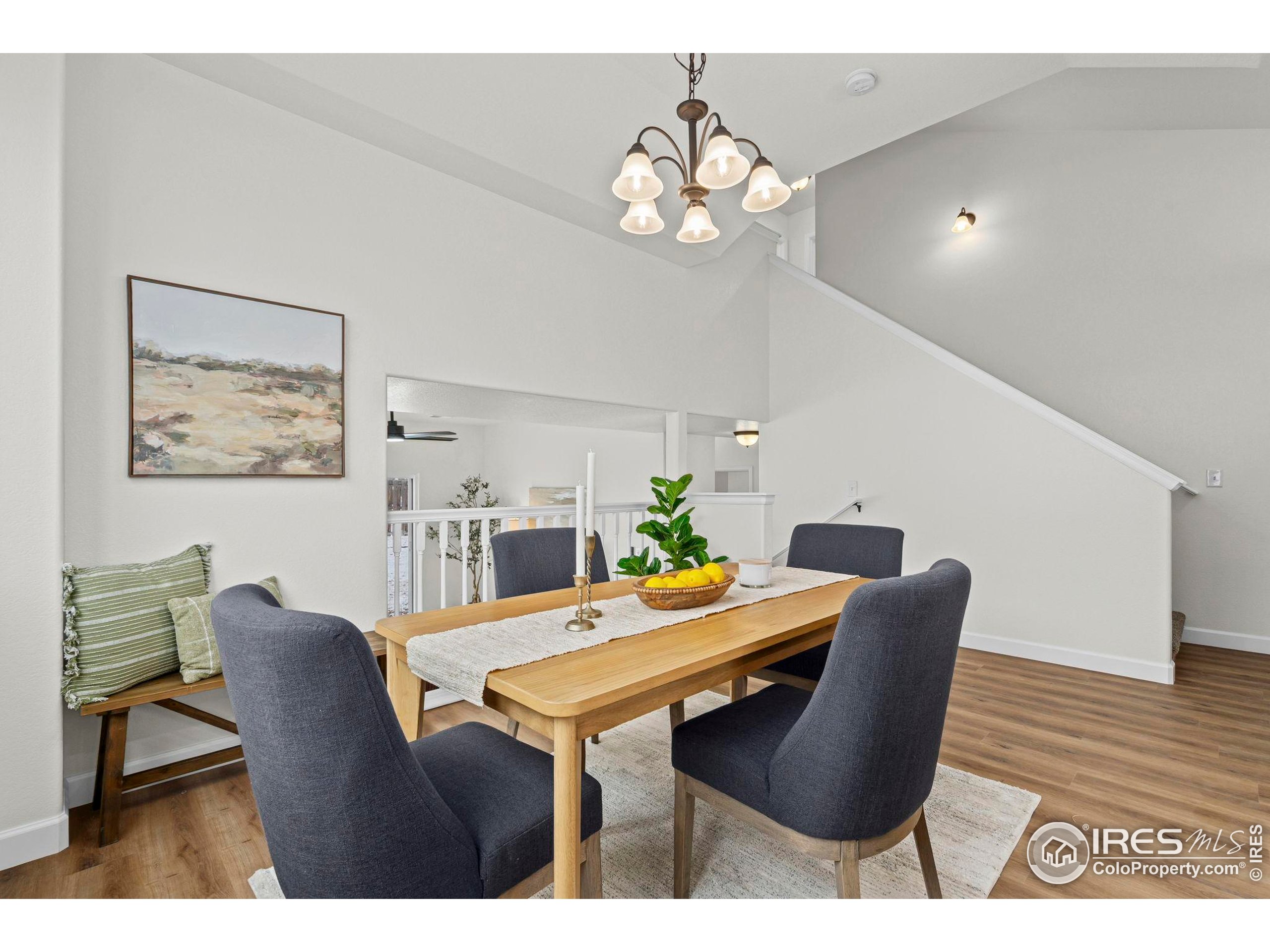 7324 Atlantis Street Wellington, CO 80549 - Photo 5 of 31 a view of a dining room with furniture and chandelier