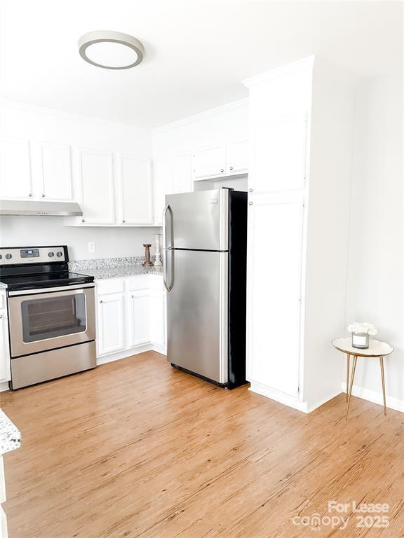 8224 Rittenhouse Circle Charlotte, NC 28270 - Photo 10 of 34 a kitchen with a refrigerator a stove top oven and white cabinets