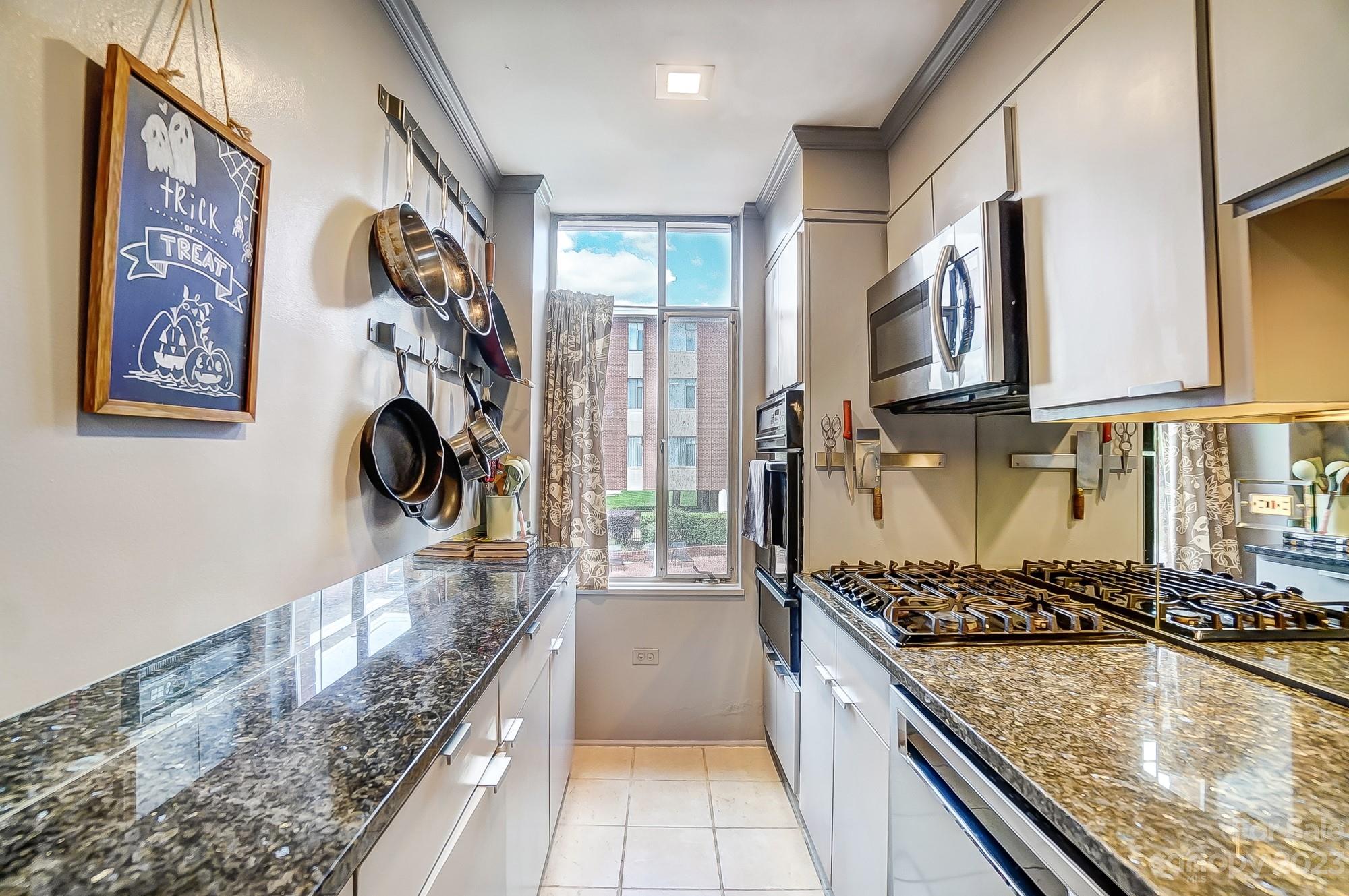 1300 Queens Road, Unit 208 Charlotte, NC 28207 - Photo 12 of 34 a kitchen with a stove and a sink