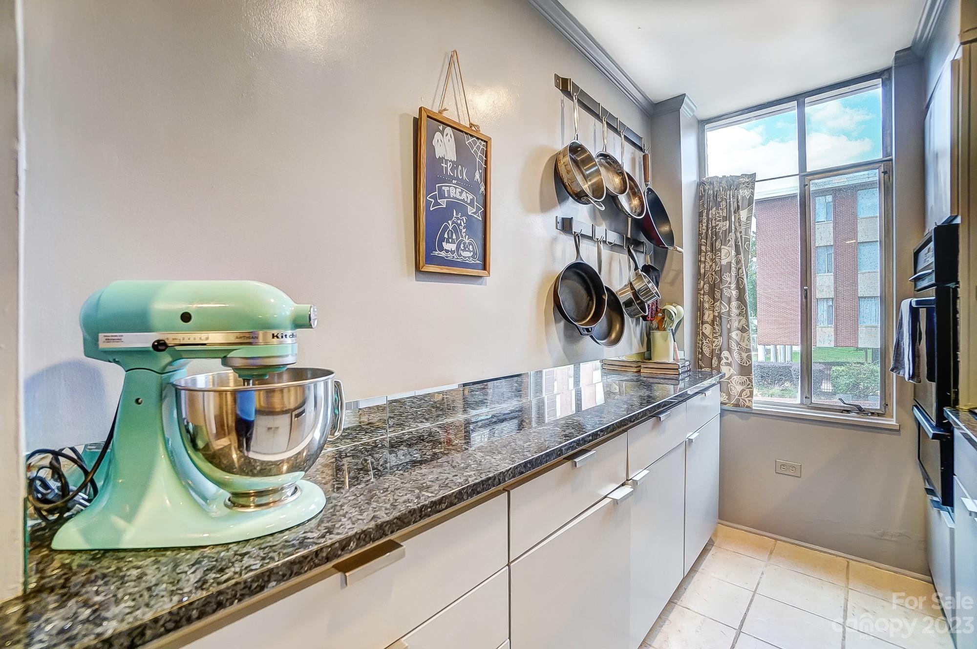 1300 Queens Road, Unit 208 Charlotte, NC 28207 - Photo 13 of 34 a kitchen with a sink and a stove with wooden floor