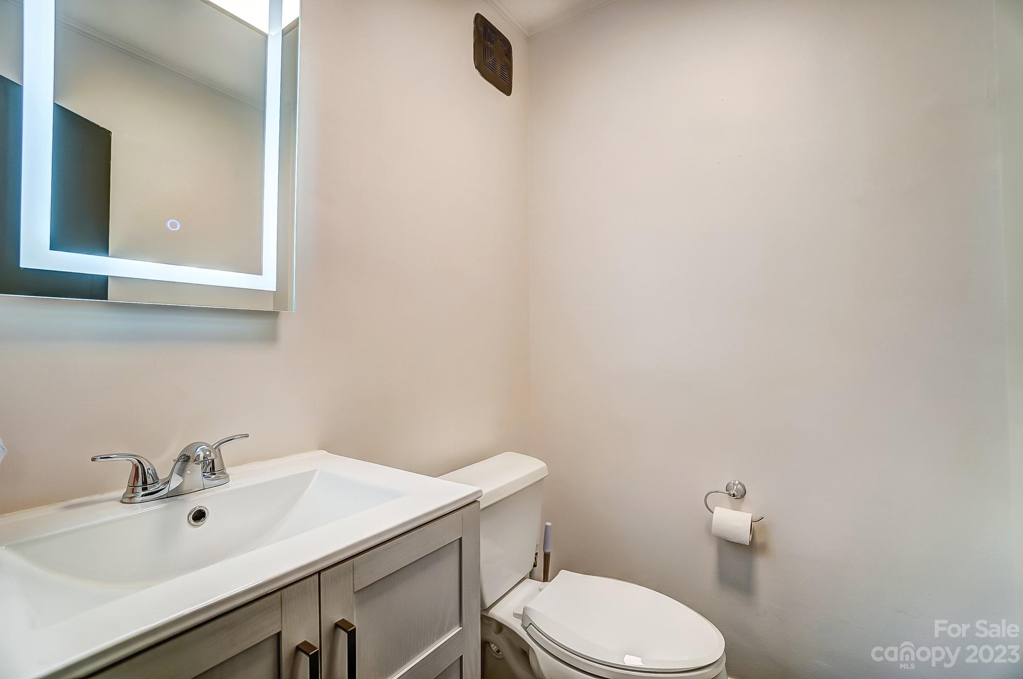1300 Queens Road, Unit 208 Charlotte, NC 28207 - Photo 17 of 34 a bathroom with a sink a toilet and mirror