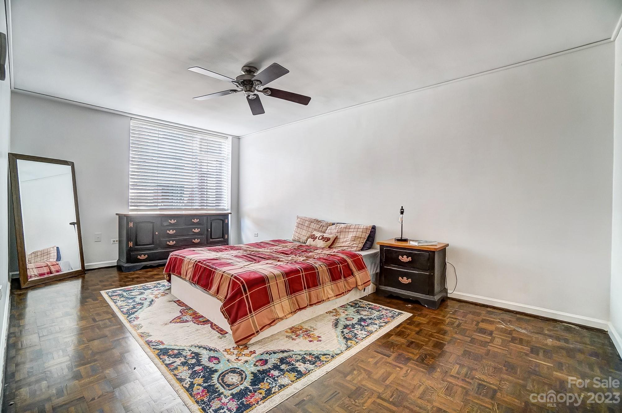 1300 Queens Road, Unit 208 Charlotte, NC 28207 - Photo 18 of 34 a bedroom with a bed and wooden floor