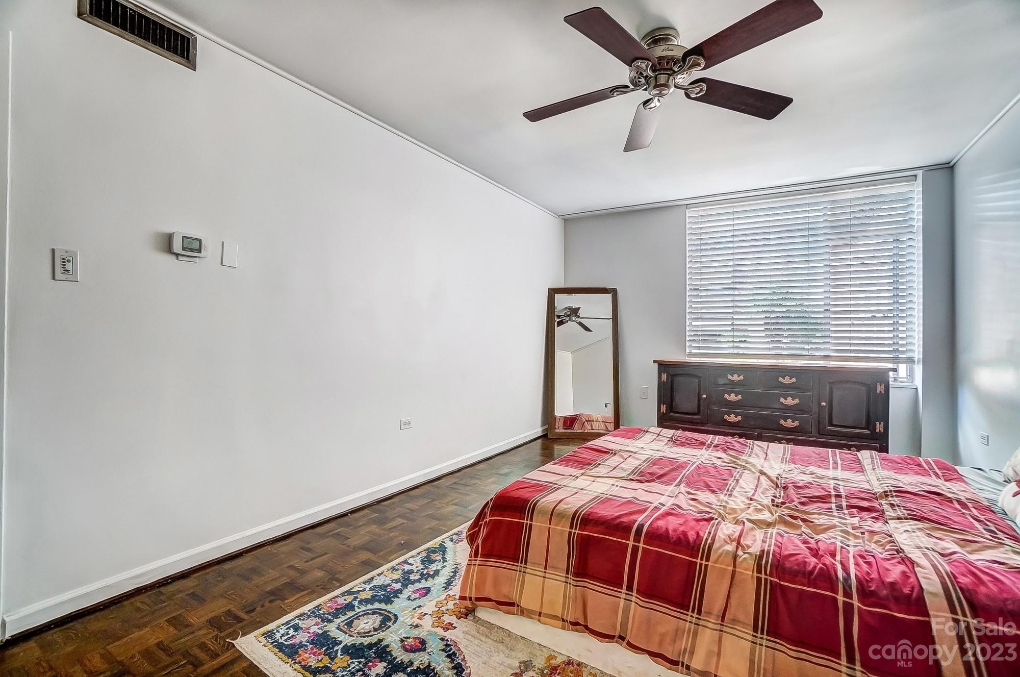 1300 Queens Road, Unit 208 Charlotte, NC 28207 - Photo 19 of 34 a bedroom with a bed and a window