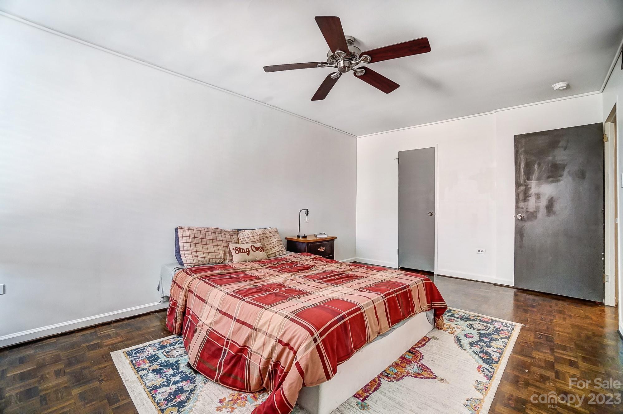 1300 Queens Road, Unit 208 Charlotte, NC 28207 - Photo 20 of 34 a bedroom with a bed and wooden floor
