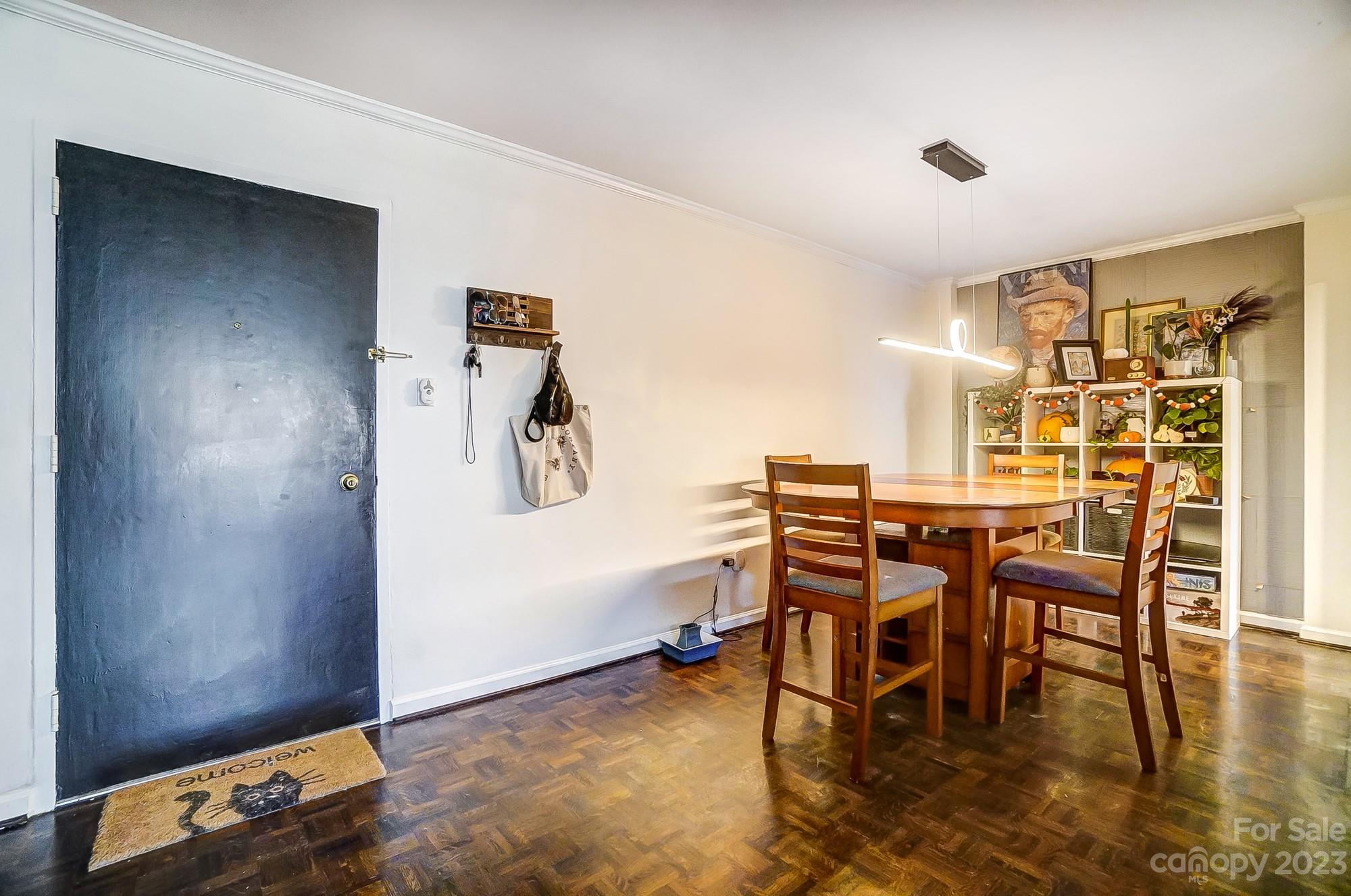 1300 Queens Road, Unit 208 Charlotte, NC 28207 - Photo 3 of 34 a view of a dining room with furniture and wooden floor
