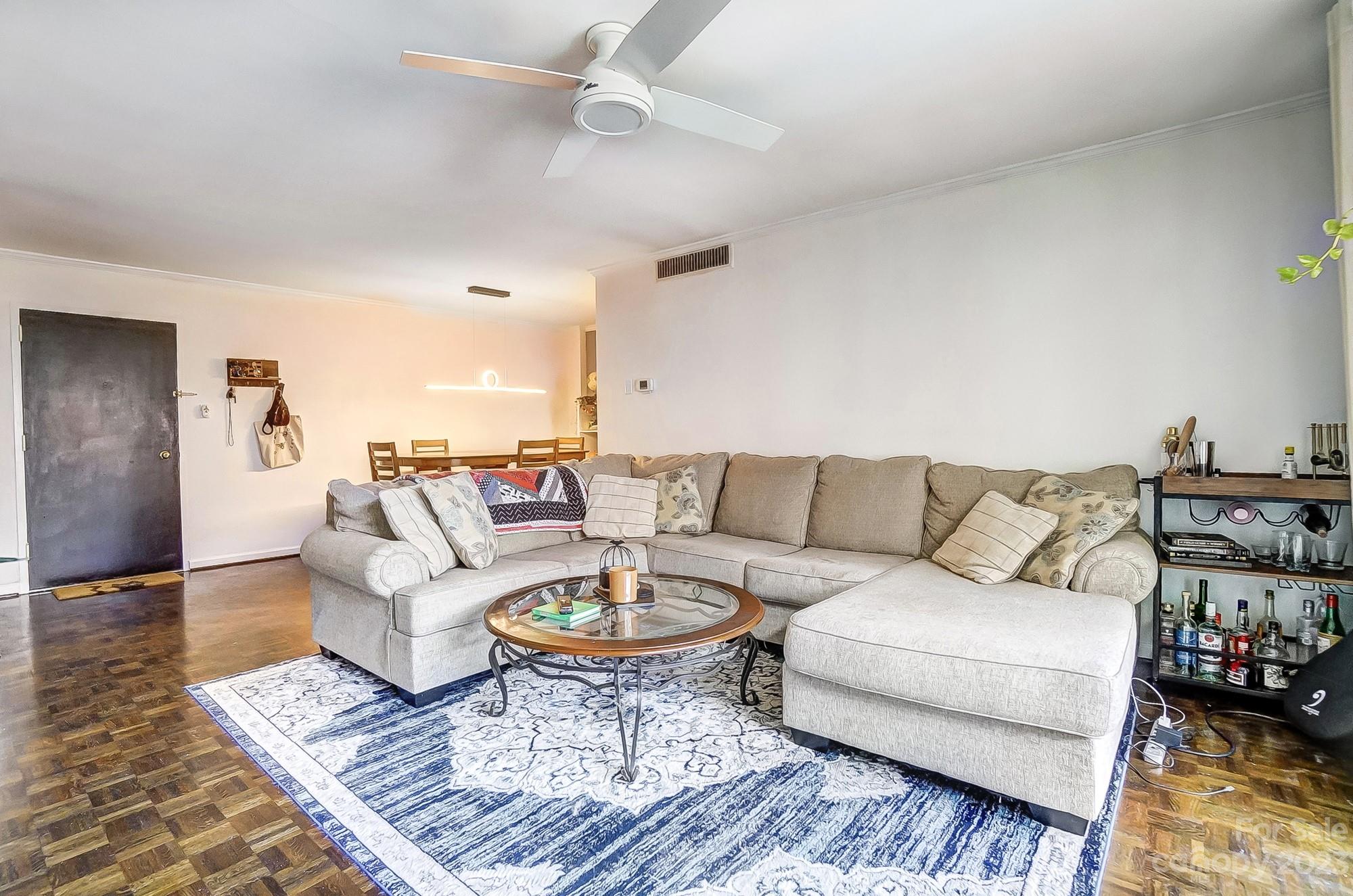 1300 Queens Road, Unit 208 Charlotte, NC 28207 - Photo 5 of 34 a living room with couches and a coffee table