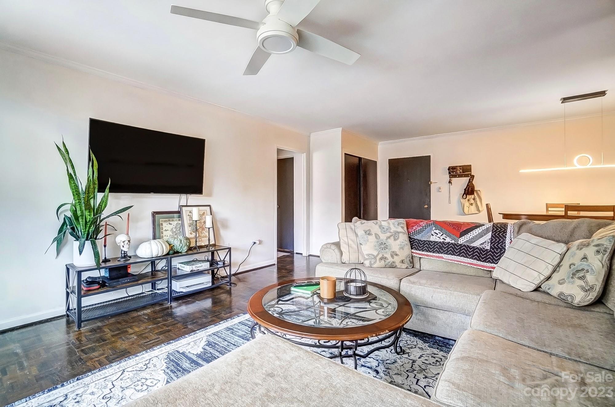 1300 Queens Road, Unit 208 Charlotte, NC 28207 - Photo 6 of 34 a living room with furniture and a flat screen tv
