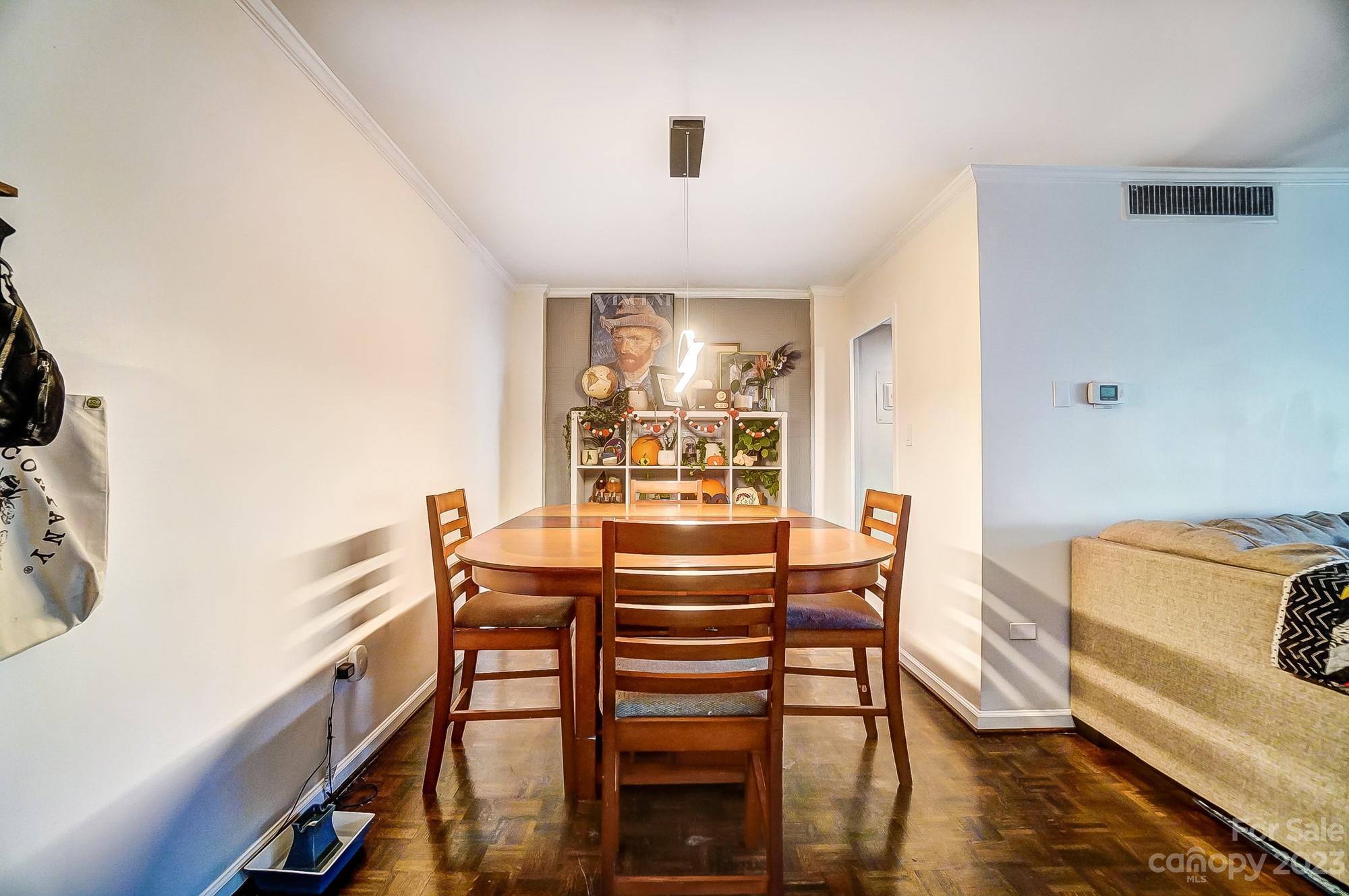 1300 Queens Road, Unit 208 Charlotte, NC 28207 - Photo 7 of 34 a view of a dining room with furniture window and wooden floor