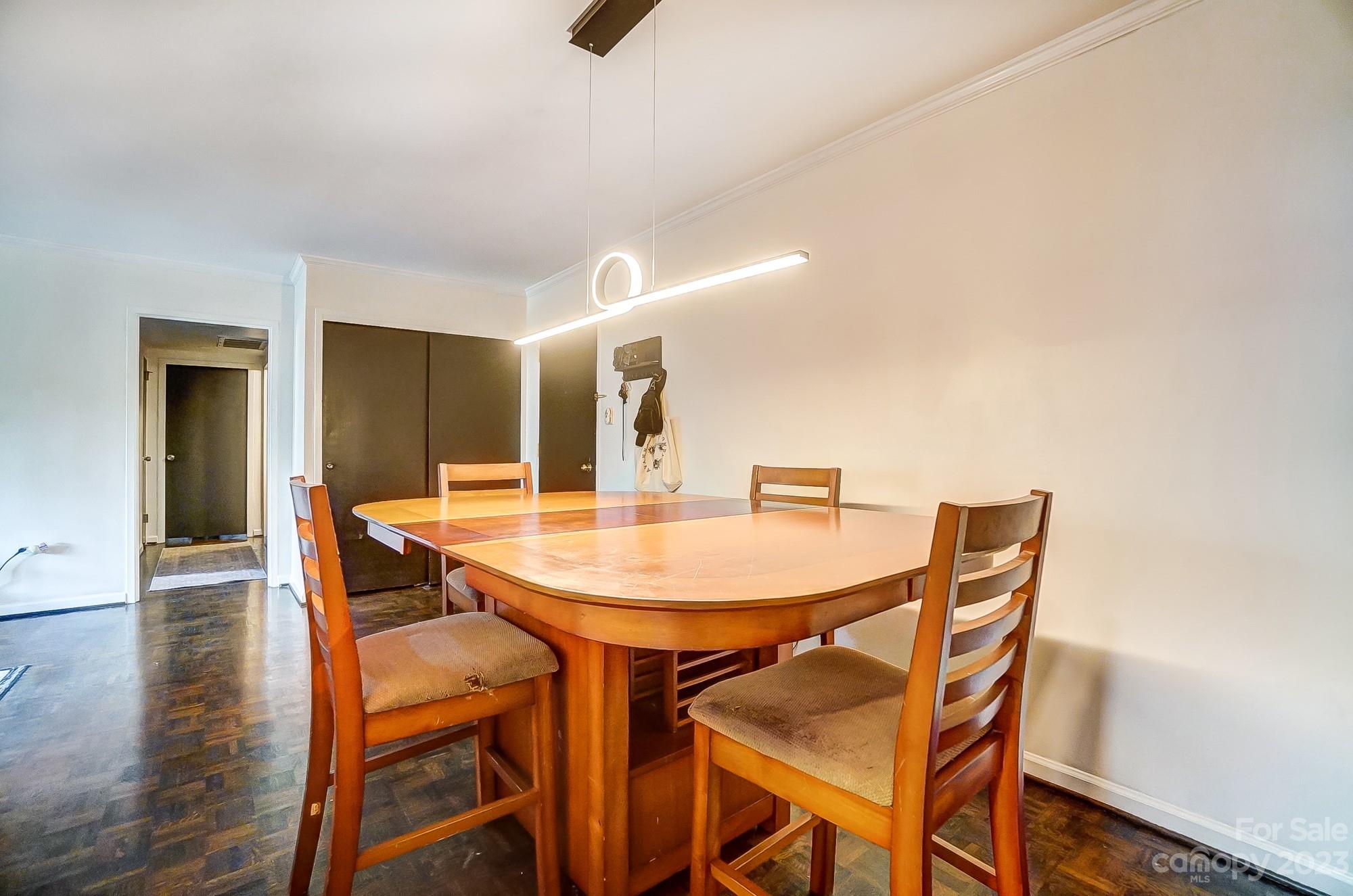 1300 Queens Road, Unit 208 Charlotte, NC 28207 - Photo 9 of 34 a dining room with furniture and wooden floor