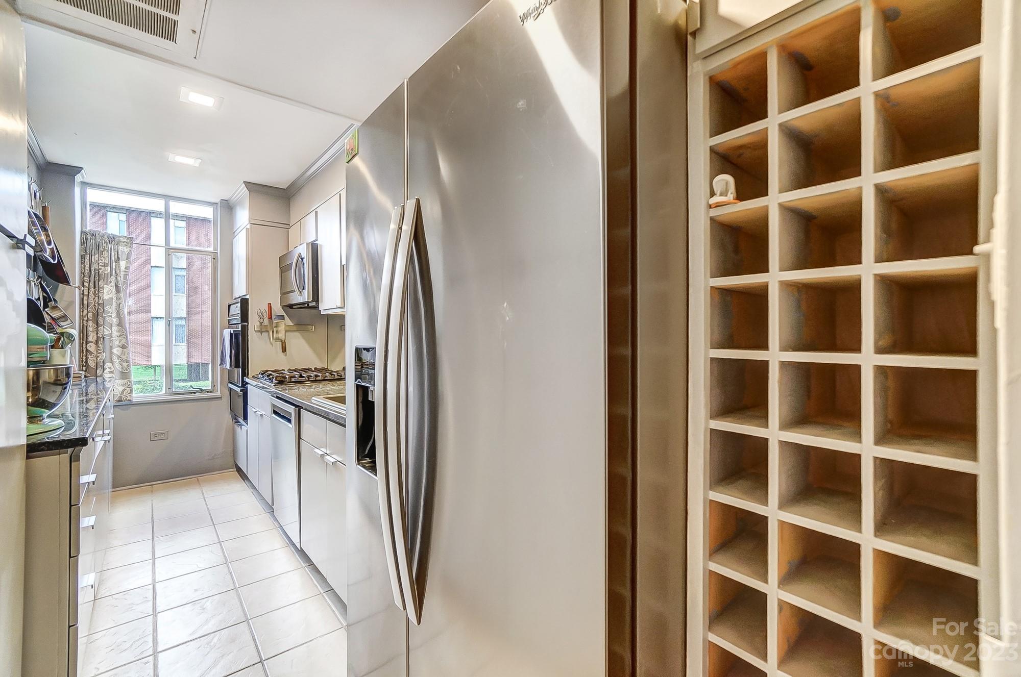 1300 Queens Road, Unit 208 Charlotte, NC 28207 - Photo 10 of 34 a kitchen with a refrigerator and a sink