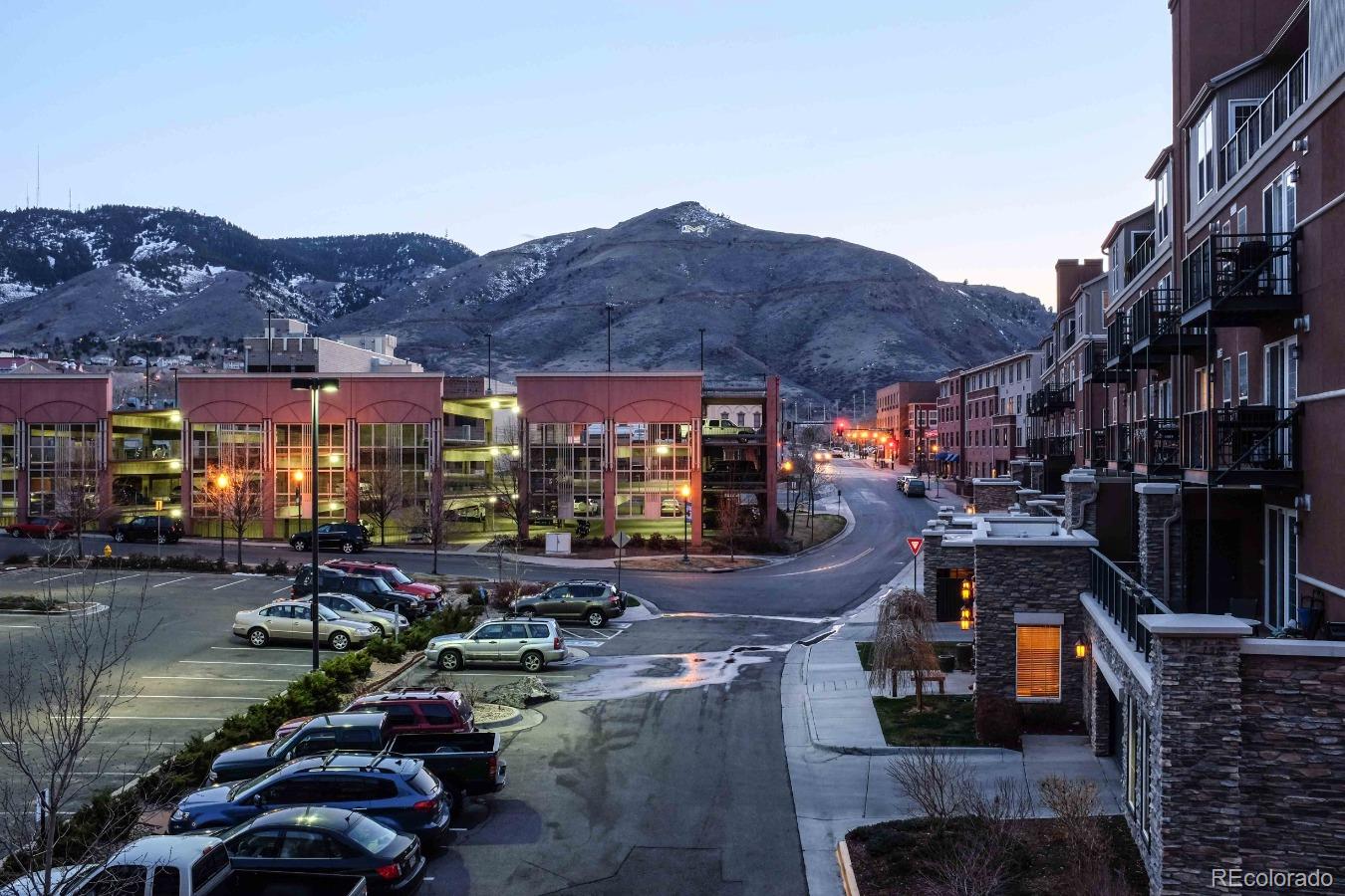 a city street filled with lots of traffic and tall buildings