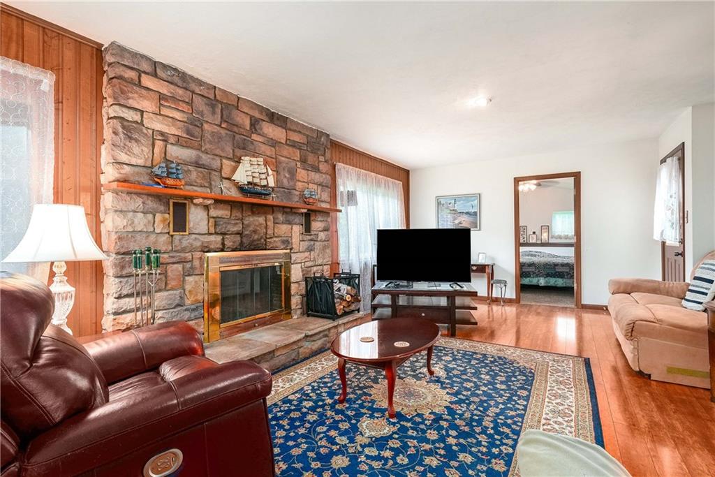 5403 Hardt Road Gibsonia, PA 15044 - Photo 14 of 41 a living room with furniture a fireplace and a flat screen tv
