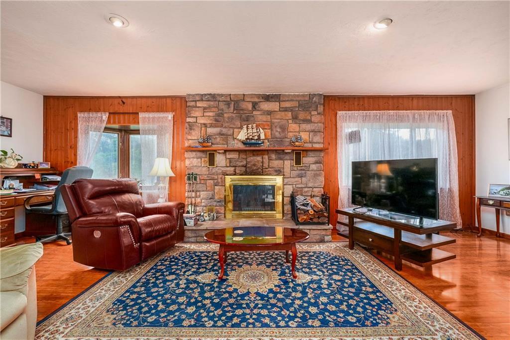 5403 Hardt Road Gibsonia, PA 15044 - Photo 15 of 41 a living room with furniture a flat screen tv and a fireplace