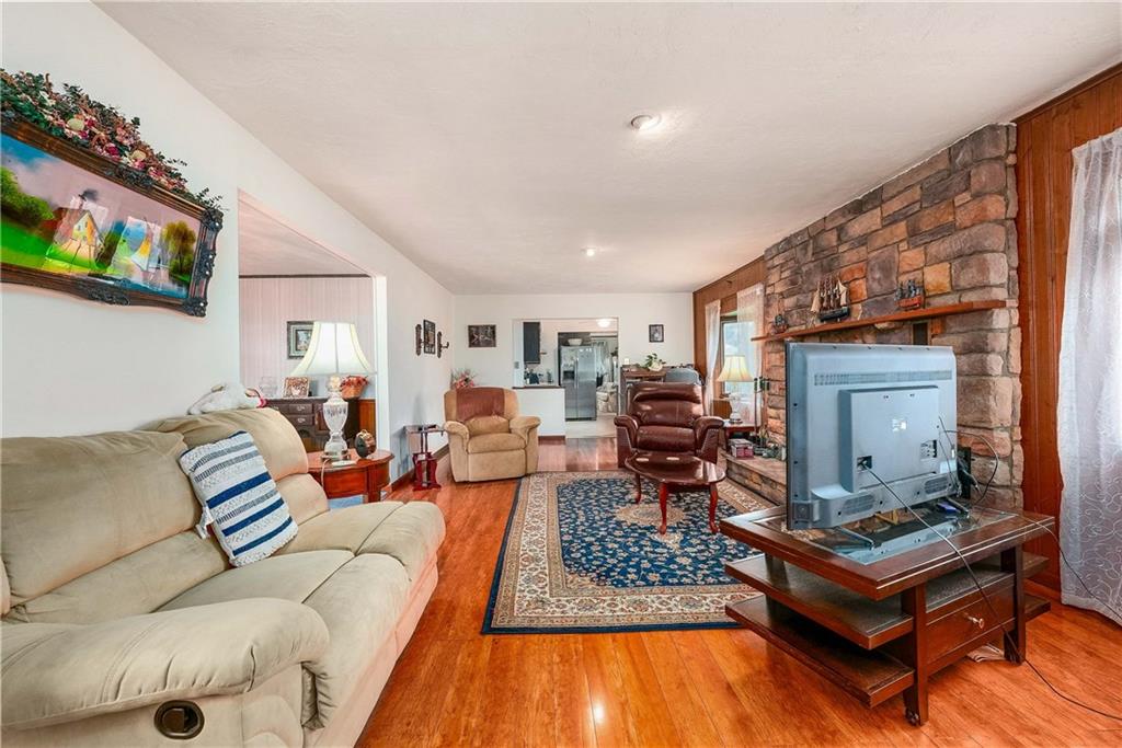 5403 Hardt Road Gibsonia, PA 15044 - Photo 16 of 41 a living room with furniture a rug and a flat screen tv