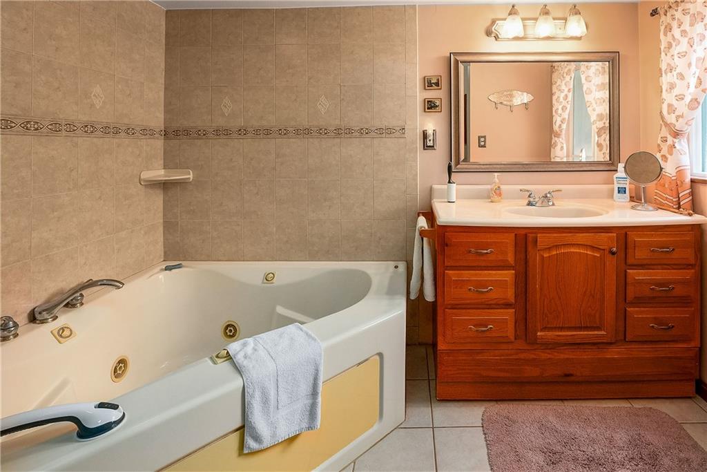 5403 Hardt Road Gibsonia, PA 15044 - Photo 21 of 41 a bathroom with a tub sink and mirror