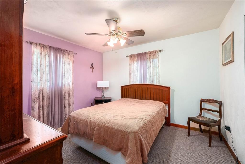 5403 Hardt Road Gibsonia, PA 15044 - Photo 23 of 41 a bedroom with a bed and a chandelier