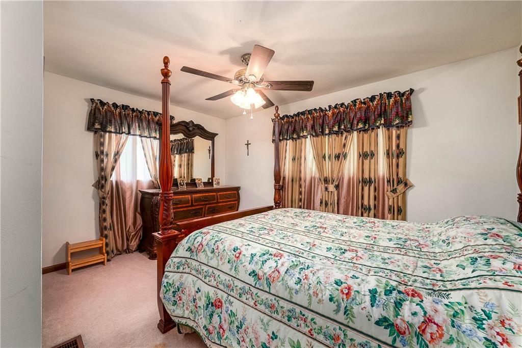 5403 Hardt Road Gibsonia, PA 15044 - Photo 24 of 41 a bedroom with a bed and a chandelier