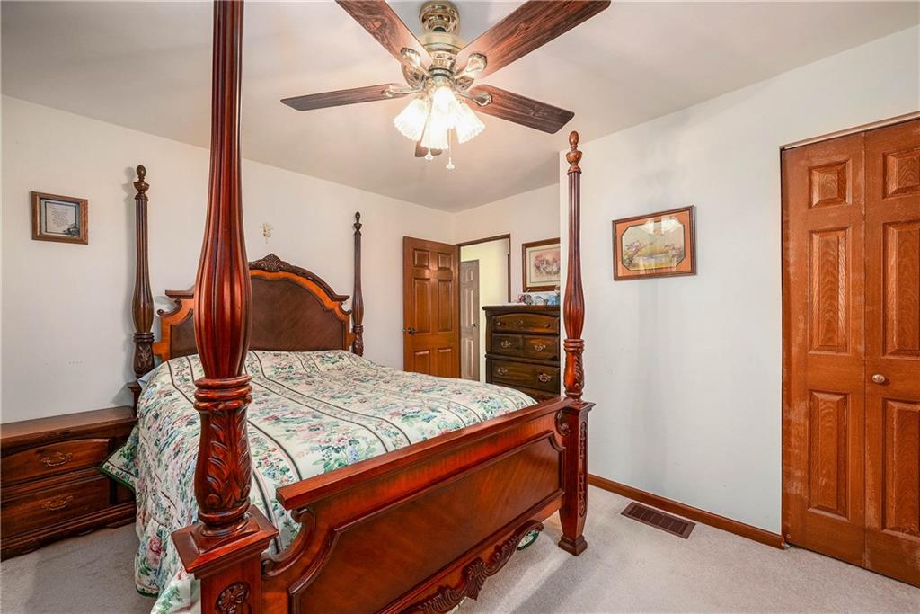 5403 Hardt Road Gibsonia, PA 15044 - Photo 25 of 41 a bedroom with a bed and a chandelier