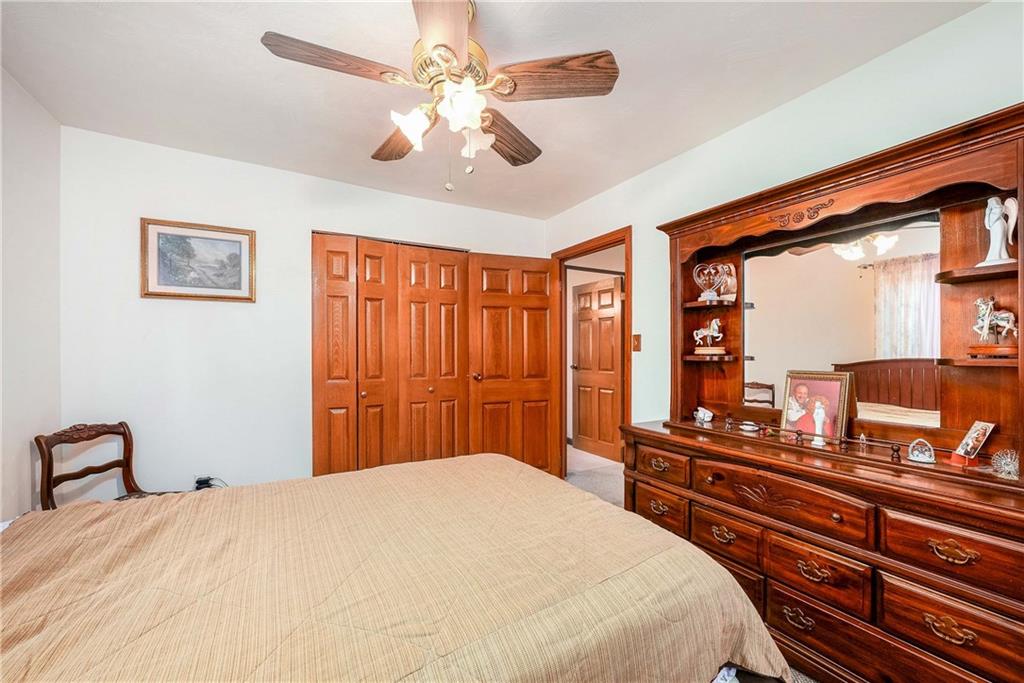 5403 Hardt Road Gibsonia, PA 15044 - Photo 26 of 41 a bedroom with a bed and a chandelier