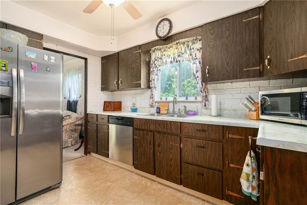 5403 Hardt Road Gibsonia, PA 15044 - Photo 8 of 41 a kitchen with a refrigerator and a sink