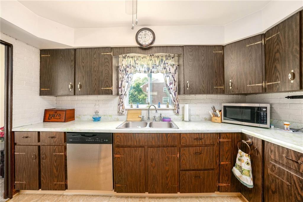 5403 Hardt Road Gibsonia, PA 15044 - Photo 9 of 41 a kitchen with stainless steel appliances a sink a stove a microwave cabinets and a window
