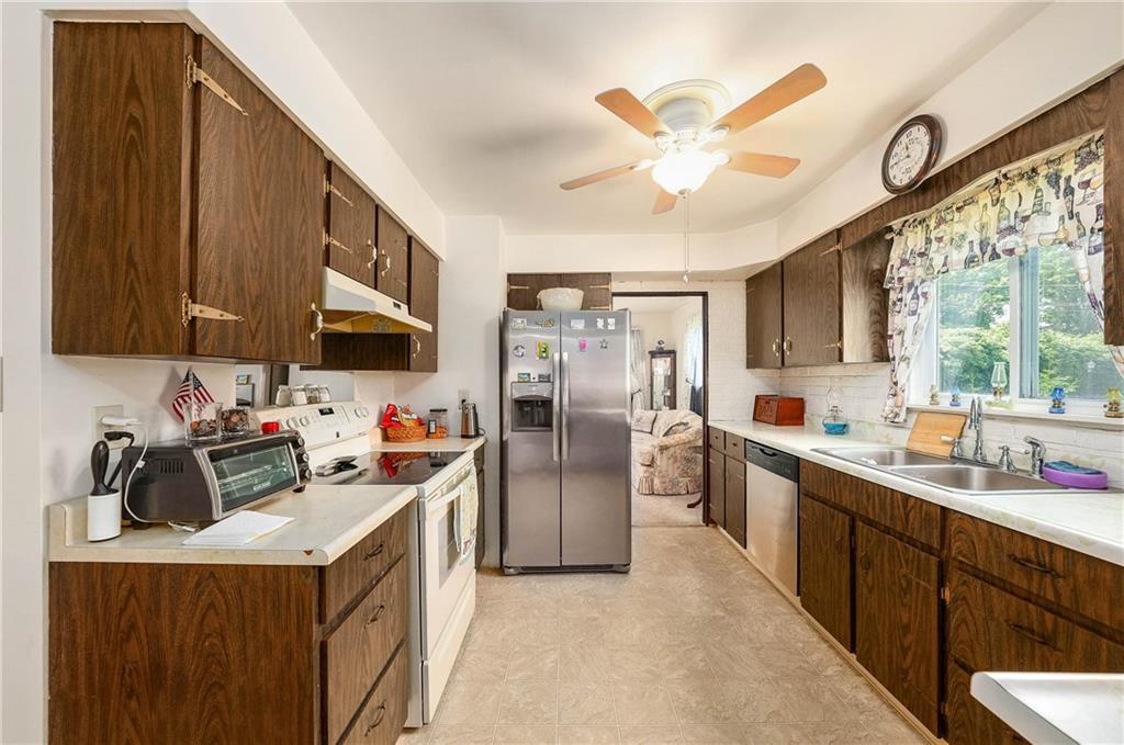 5403 Hardt Road Gibsonia, PA 15044 - Photo 10 of 41 a kitchen that has a lot of cabinets a sink and appliances