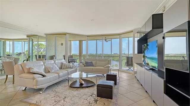 a living room with furniture and a view of kitchen