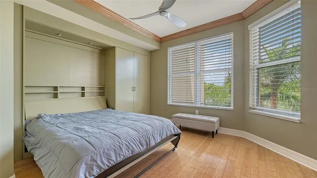 a front view of a house with a yard and palm trees