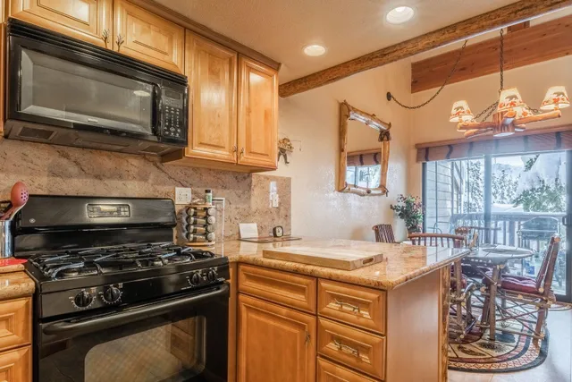 a kitchen with a stove a sink and a microwave