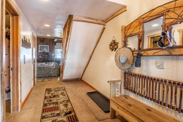 a view of a hallway with wooden floor and stairs