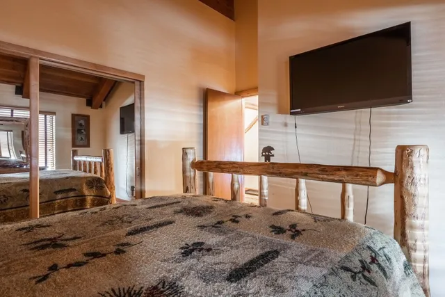 a bedroom with furniture and a flat screen tv