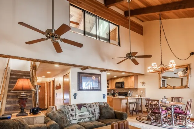 a living room with fireplace furniture and a ceiling fan
