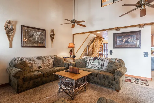 a living room with furniture a rug and a window