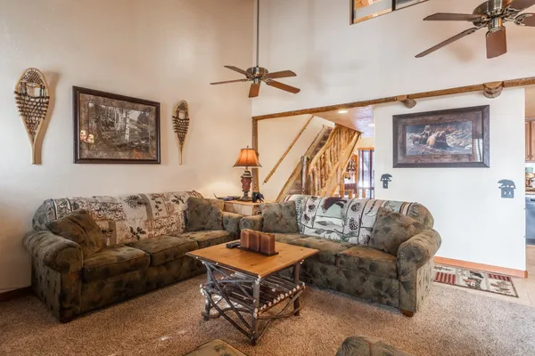 a living room with furniture a rug and a window