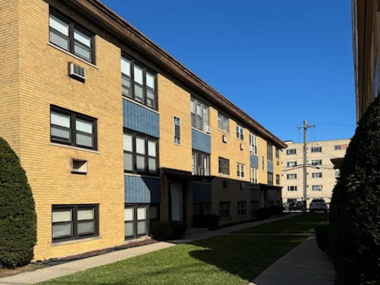 9209 South Cottage Grove Avenue, Unit A6 Chicago, IL 60619 - Photo 1 of 12 a large building with a yard in front of it