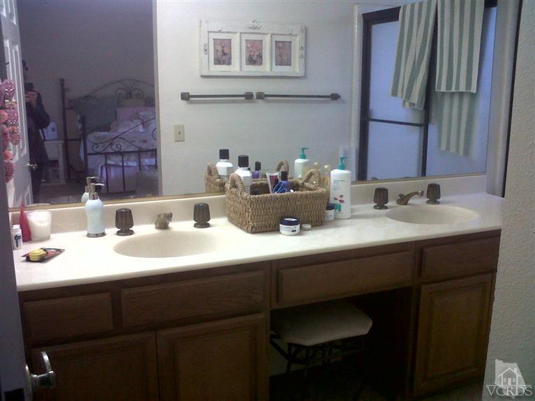 596 Fresh Meadows Road Simi Valley, CA 93065 - Photo 13 of 16 a bathroom with a sink and a mirror