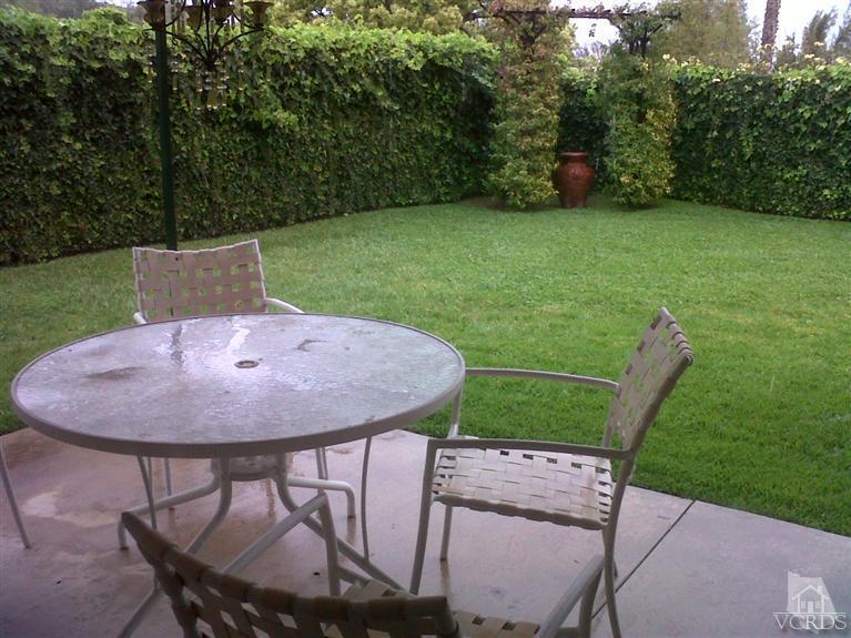 596 Fresh Meadows Road Simi Valley, CA 93065 - Photo 15 of 16 a view of a backyard with table and chairs a barbeque grill and a small yard
