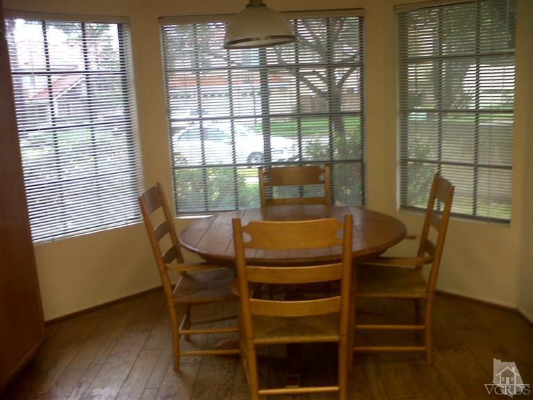 596 Fresh Meadows Road Simi Valley, CA 93065 - Photo 7 of 16 a dining room with furniture and wooden floor