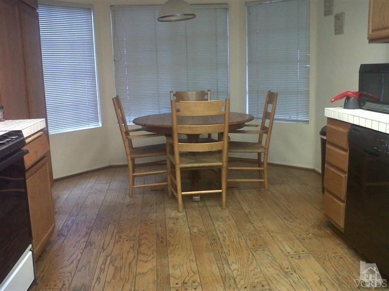 596 Fresh Meadows Road Simi Valley, CA 93065 - Photo 8 of 16 a dining room with furniture and wooden floor