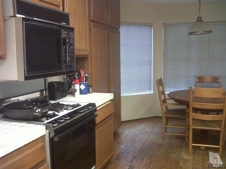 596 Fresh Meadows Road Simi Valley, CA 93065 - Photo 9 of 16 a kitchen with a stove and a microwave oven