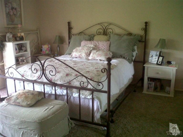596 Fresh Meadows Road Simi Valley, CA 93065 - Photo 10 of 16 a bedroom with a bed and a chandelier